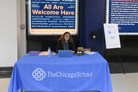 woman smiling at blue table cloth sign up desk