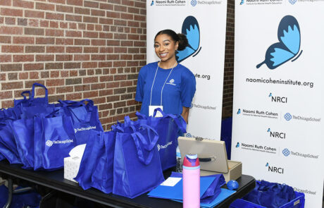 woman from The Chicago School handing out tote bags