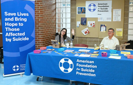 man and woman at american foundation for suicide prevention booth