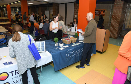 man talking to woman at display table