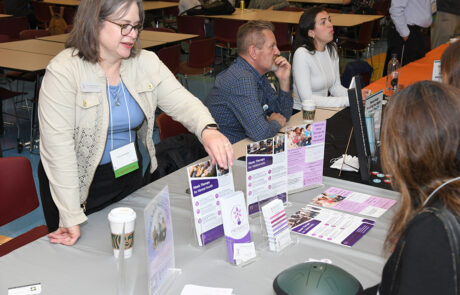 woman showing someone literature on music therapy for mental health