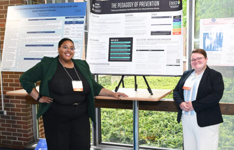two women wearing glasses standing by displays