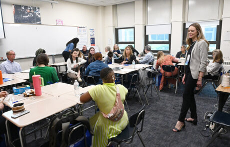 woman standing in the middle of a classroom speaking
