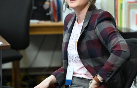 woman with glasses sitting in a chair