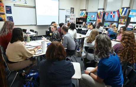 group of adults in a high school classroom