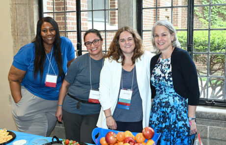 four women behind snack table